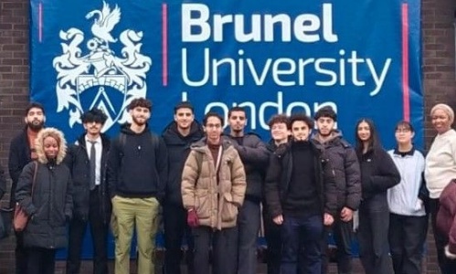 Students standing in front of Brunel University sign 